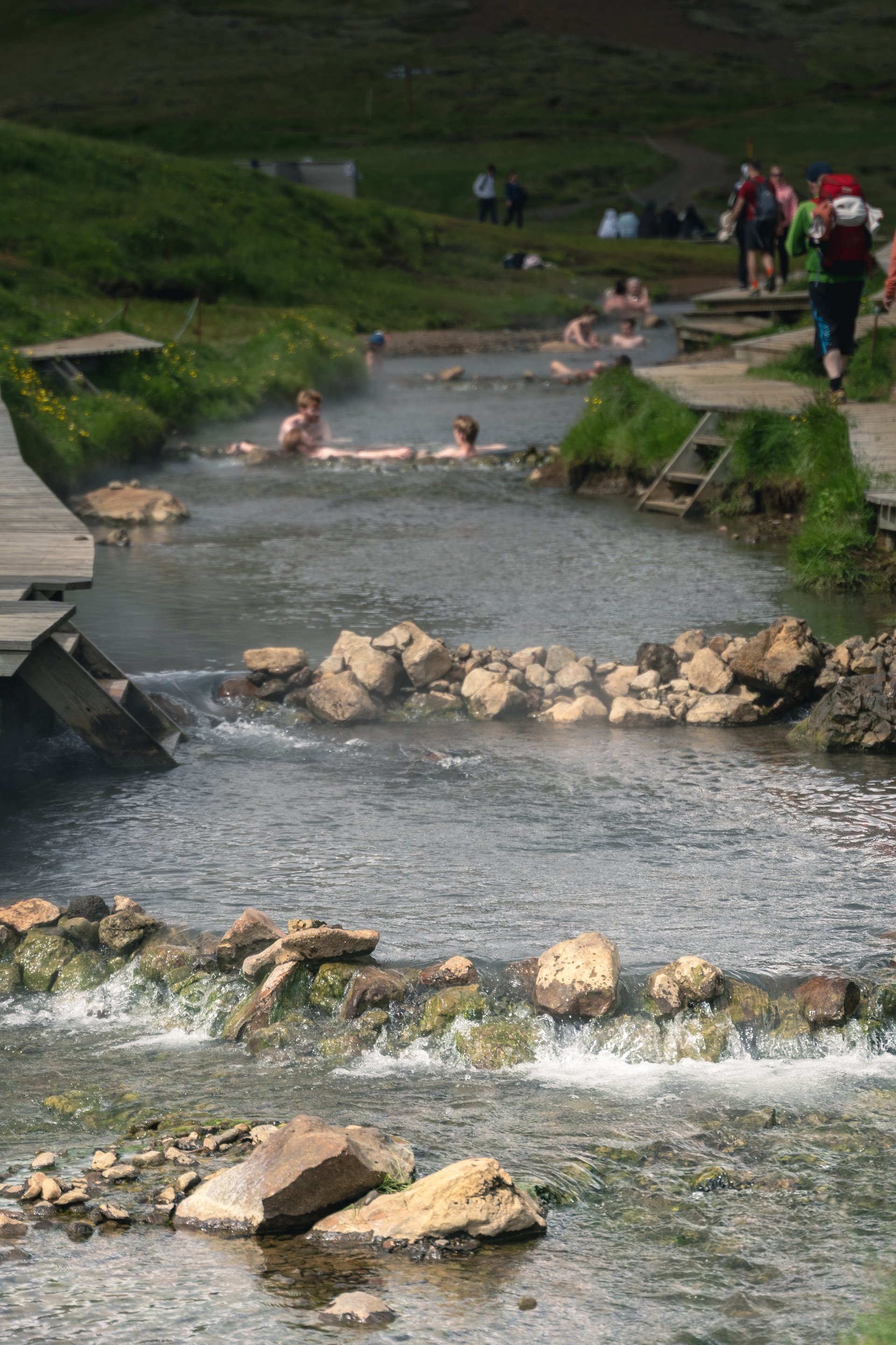 Hikers relaxing in the Reykjadalur hot river