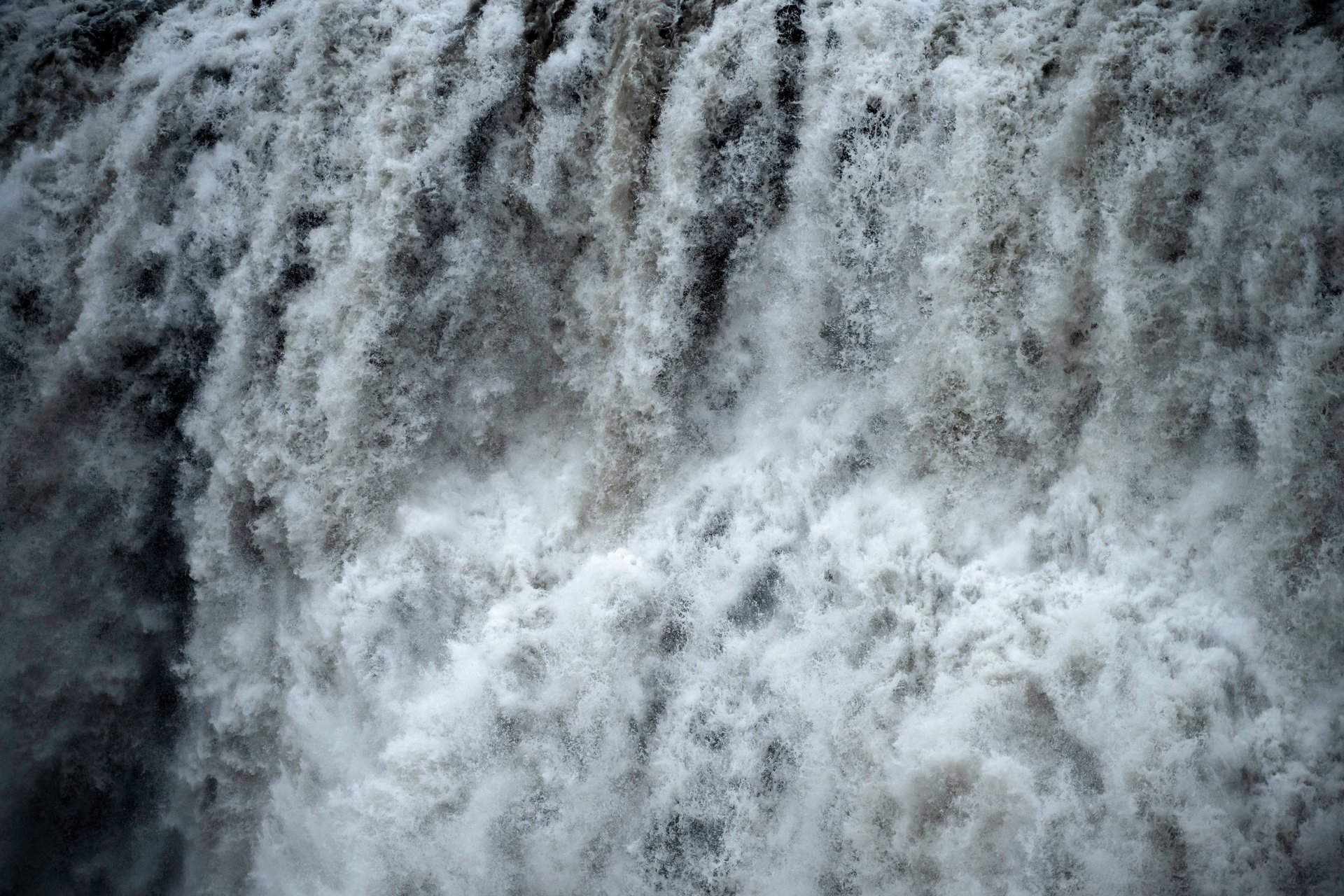 Massive spray cloud rising from Dettifoss in the volcanic desert