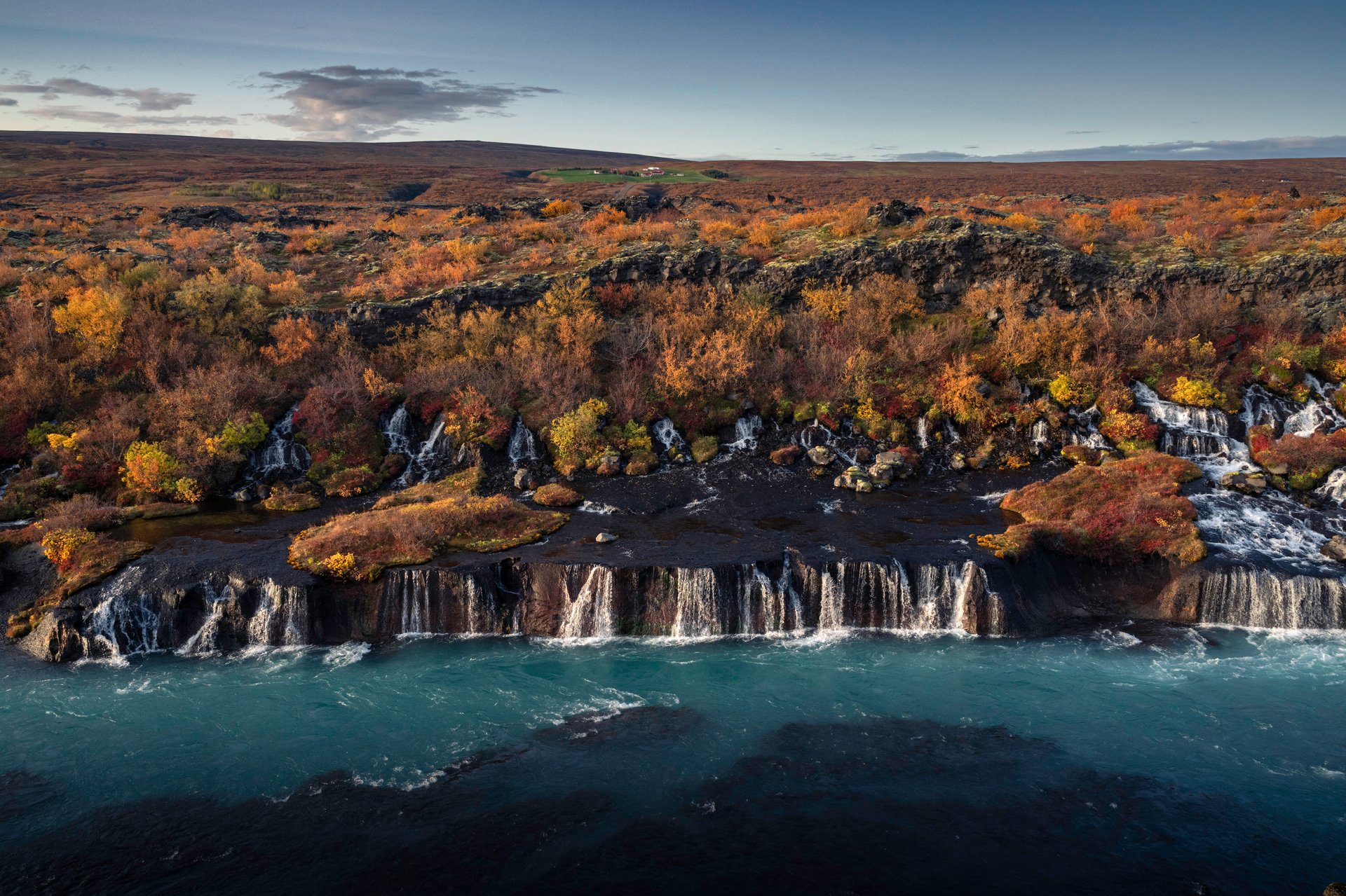 Hraunfossar lava waterfalls with rivulets emerging from the lava field