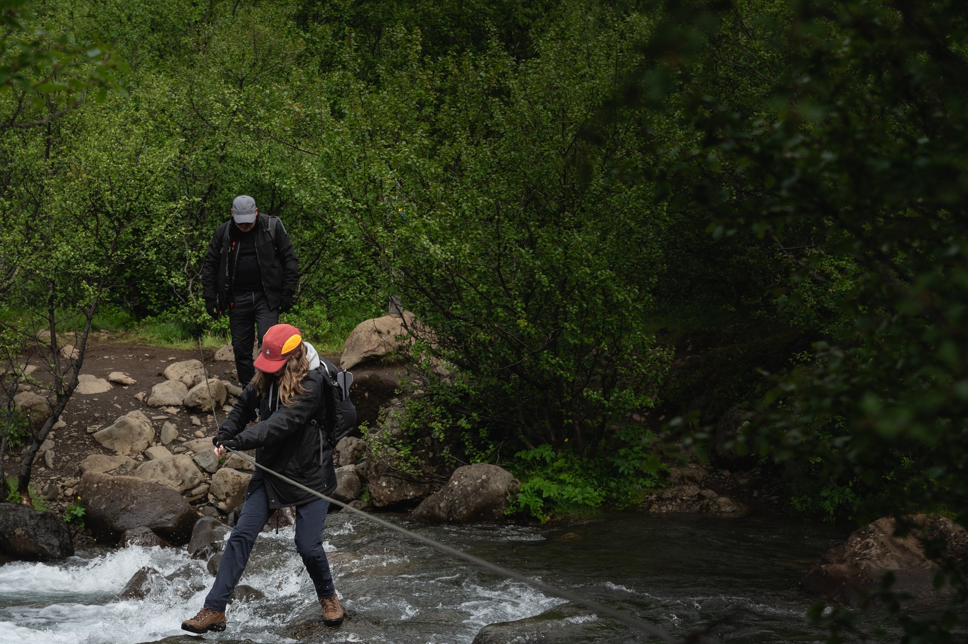 River crossing Glymur Louis helping family adventure