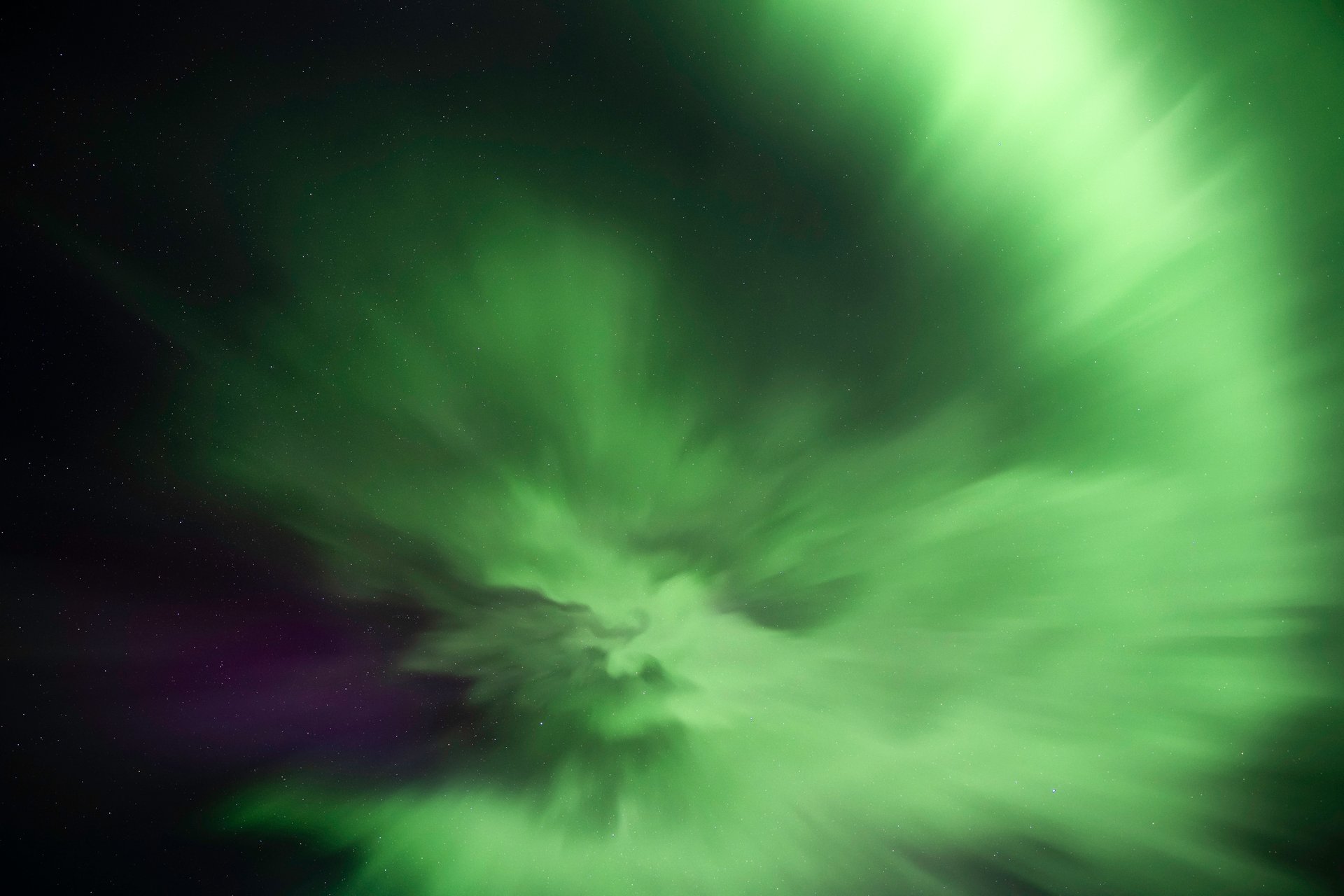 Northern Lights photograph showing pink and green aurora