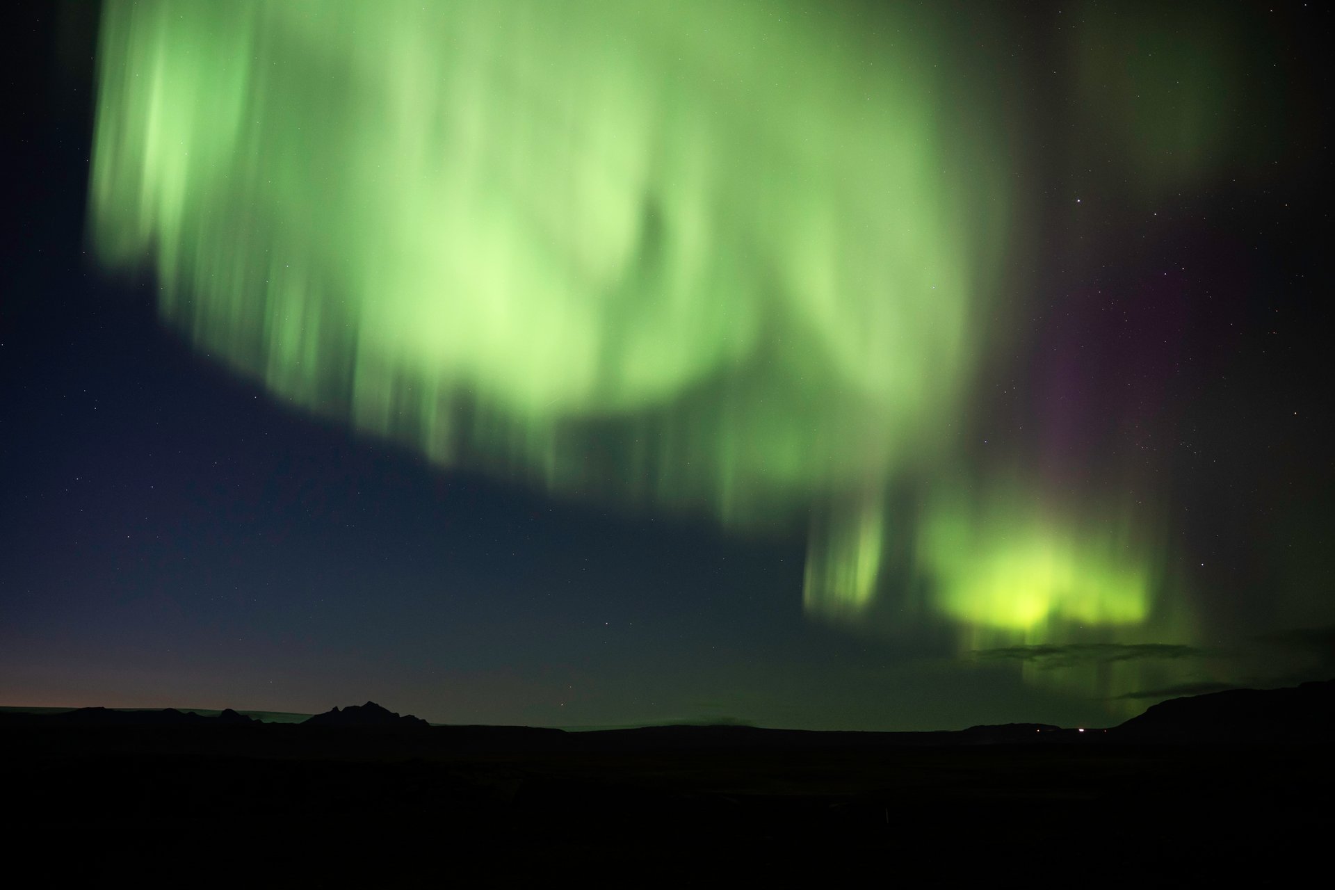 Aurora borealis with vibrant green colors over Iceland
