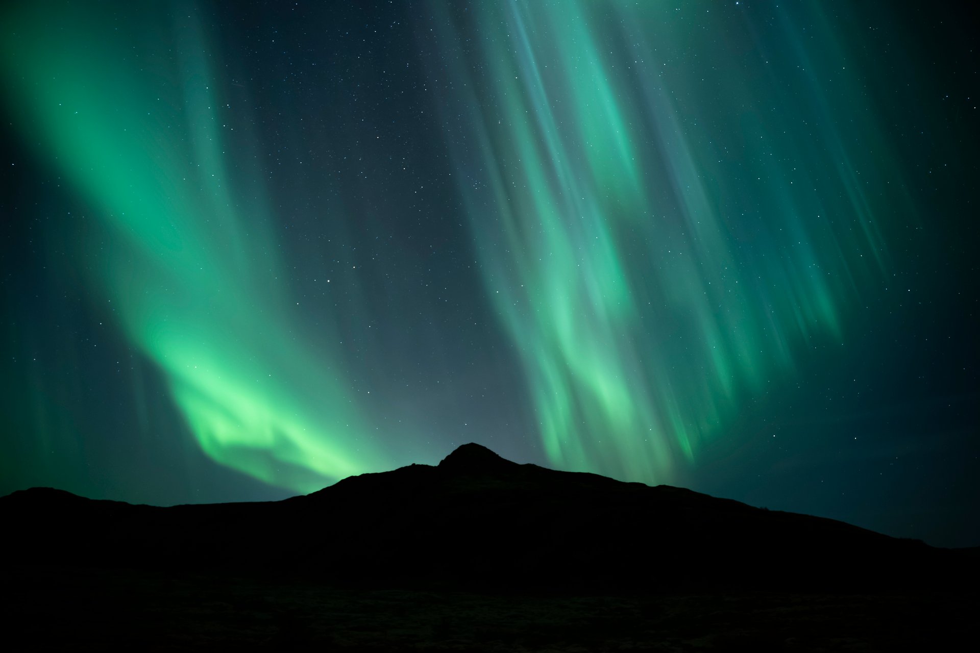 Northern Lights aurora borealis dancing over Iceland landscape