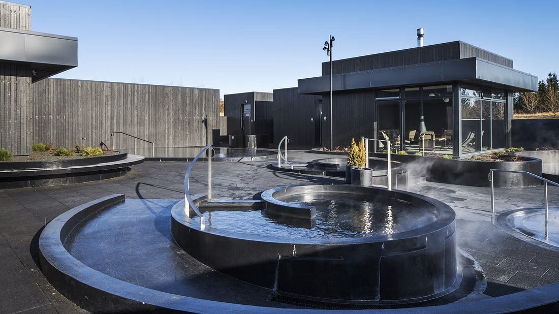 Krauma geothermal baths Iceland with steam rising from hot pools