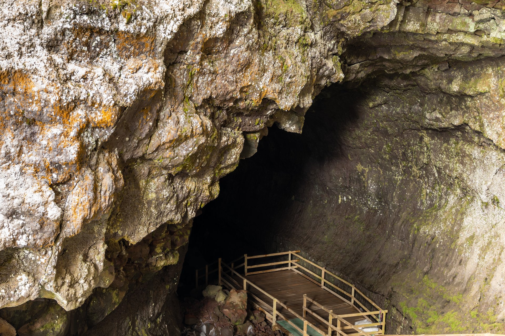 Inside Víðgelmir lava cave showing colorful rock formations