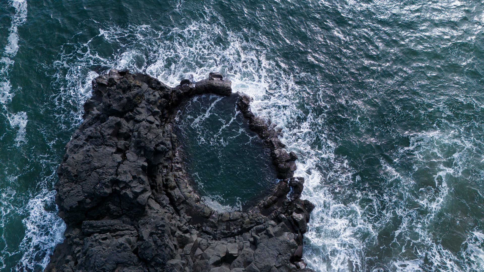 Brimketill natural lava pool Iceland Atlantic coast