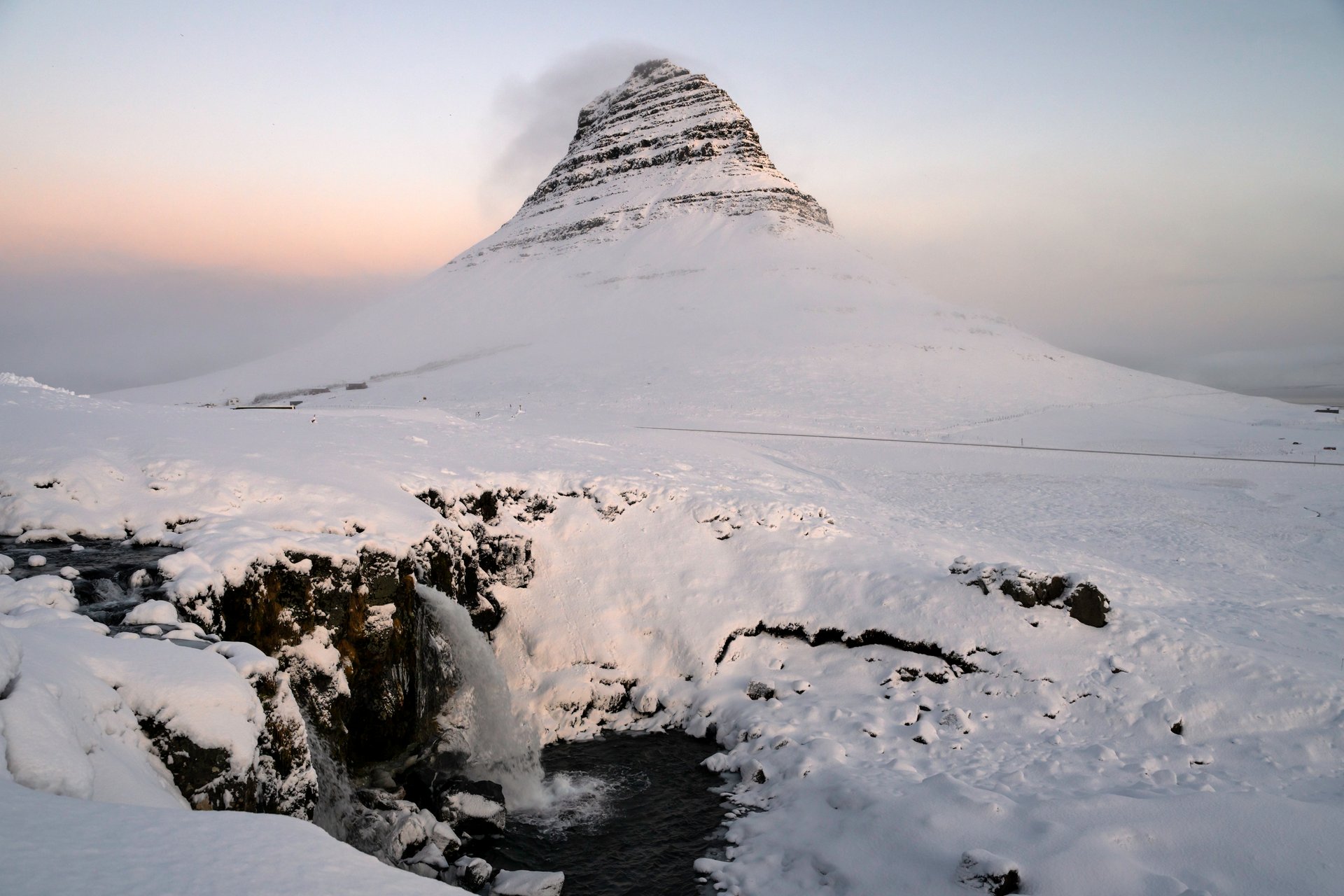 Kirkjufell reflection in water with Kirkjufellsfoss Iceland
