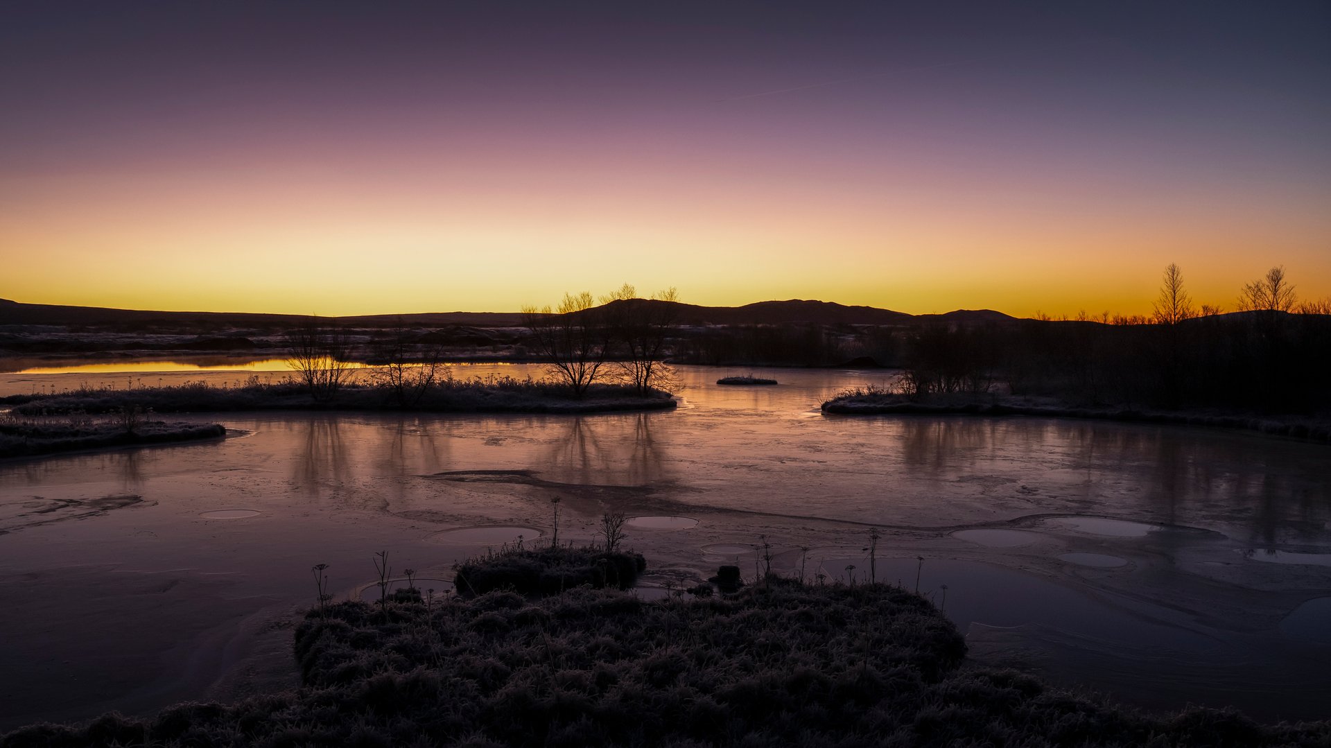Dramatic winter sunset with pink and orange skies over Iceland