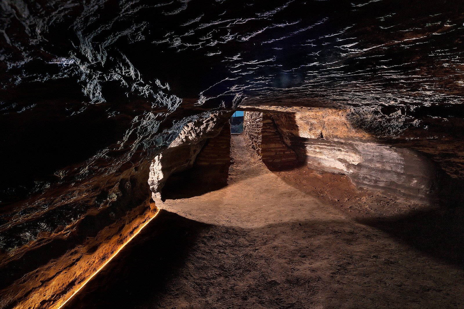 Stone seats carved into cave walls at Caves of Hella