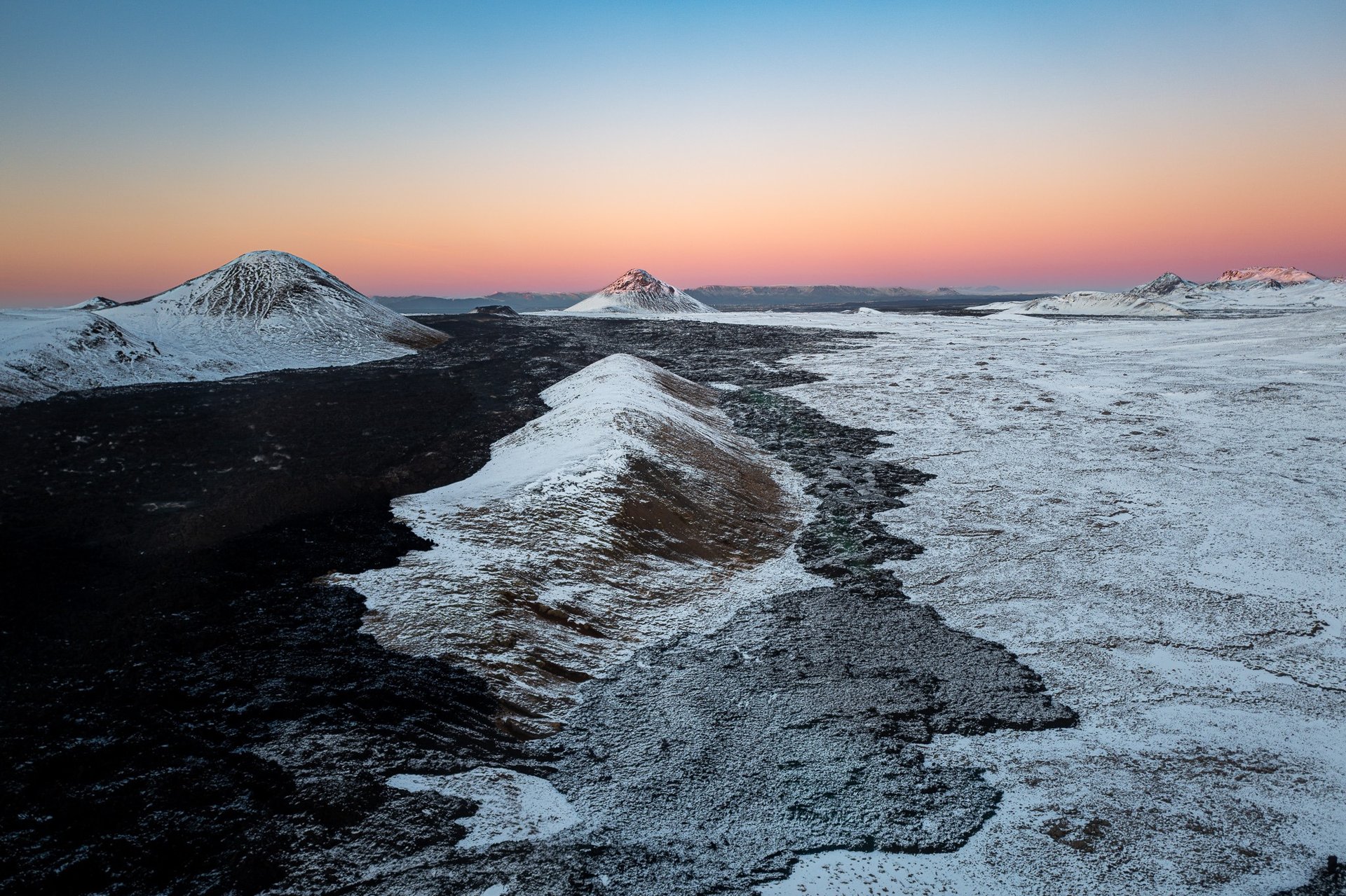 Aerial perspective of volcanic crater and surrounding terrain