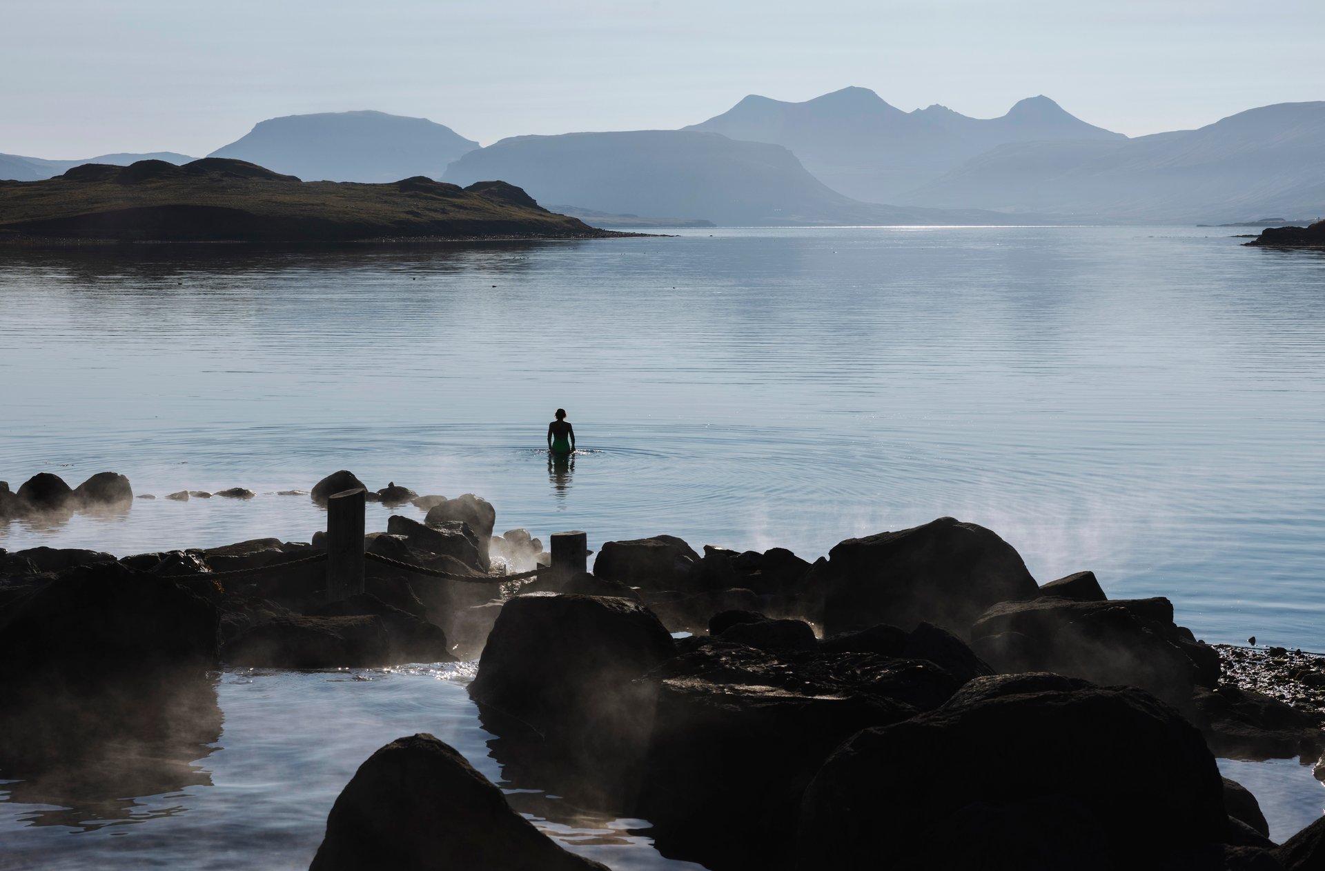 Natural hot springs pools overlooking ocean at Hvammsvík Iceland
