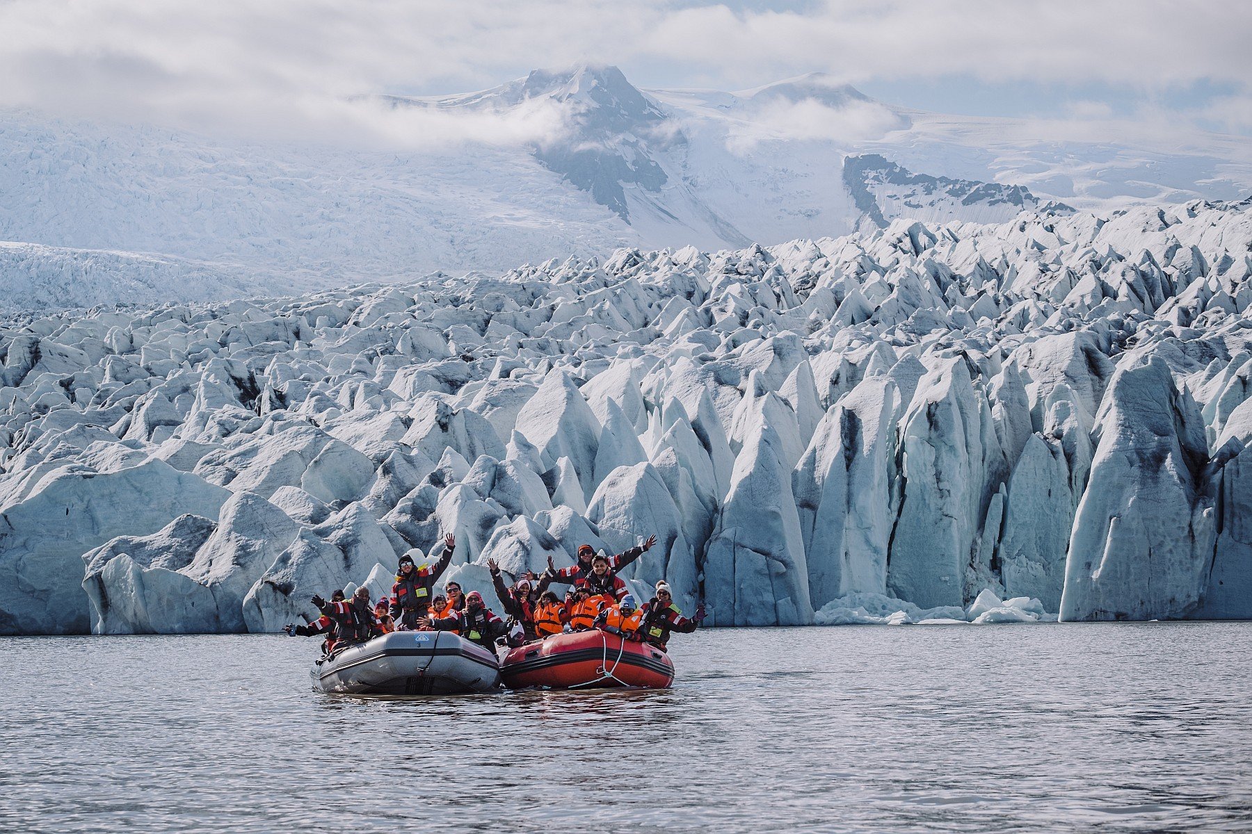 Towering glacial ice formations with mountain backdrop at Fjallsárlón