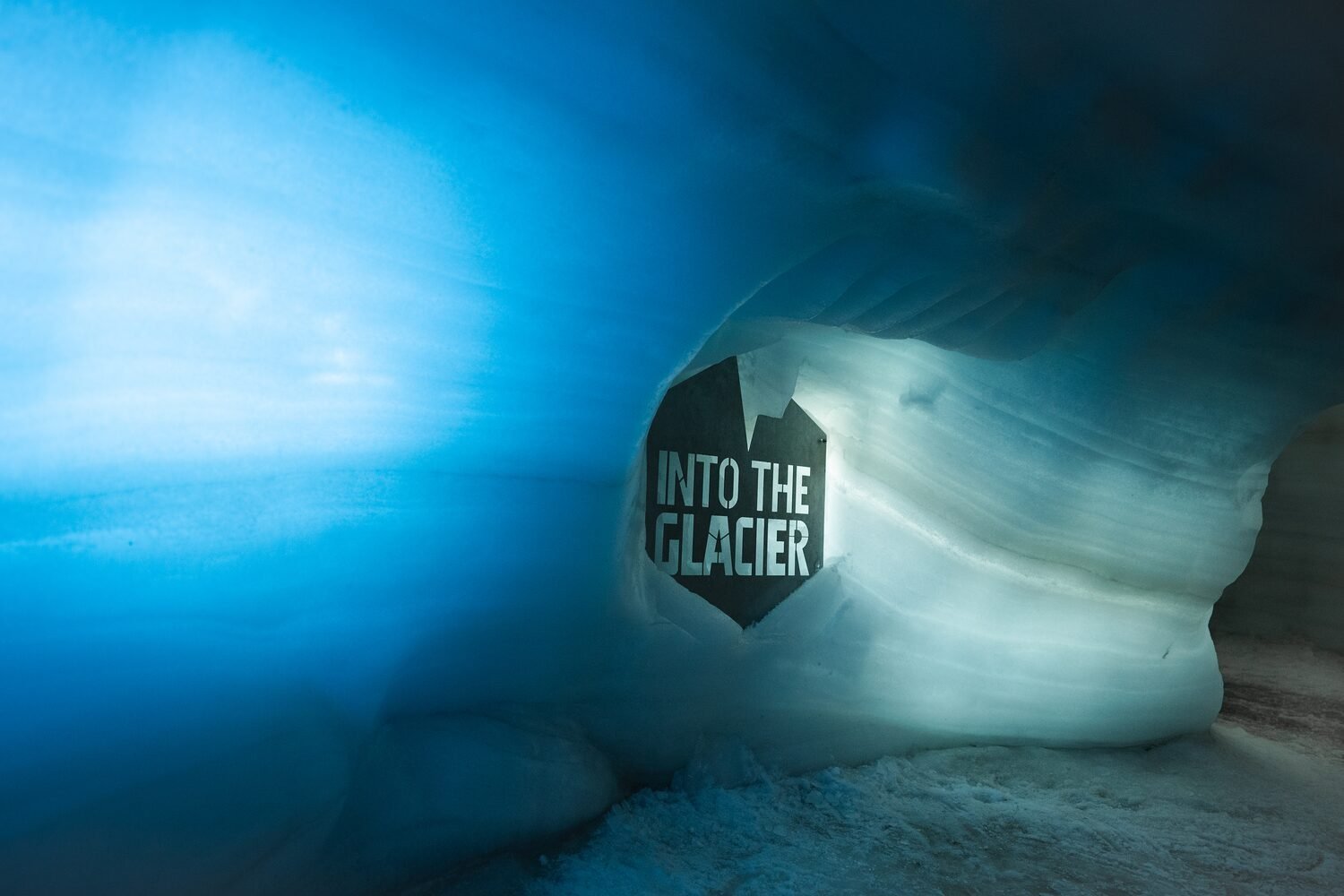 Illuminated blue ice tunnel inside Langjökull glacier in Iceland