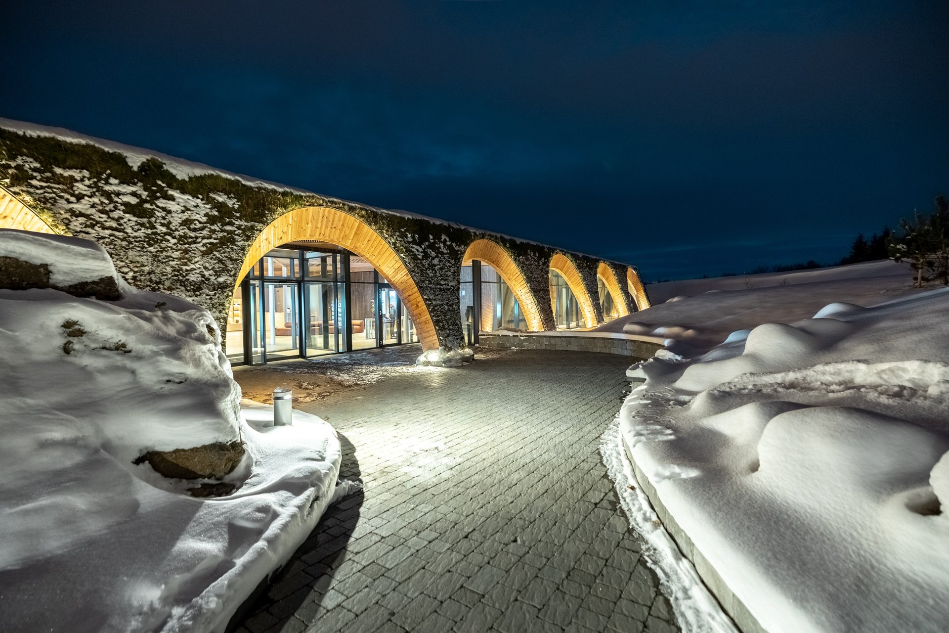Two-story geothermal lagoon with mountain backdrop at Laugarás