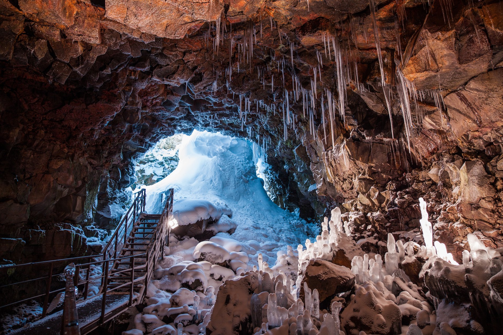 The Lava Tunnel Raufarhólshellir with colored lighting and footbridge