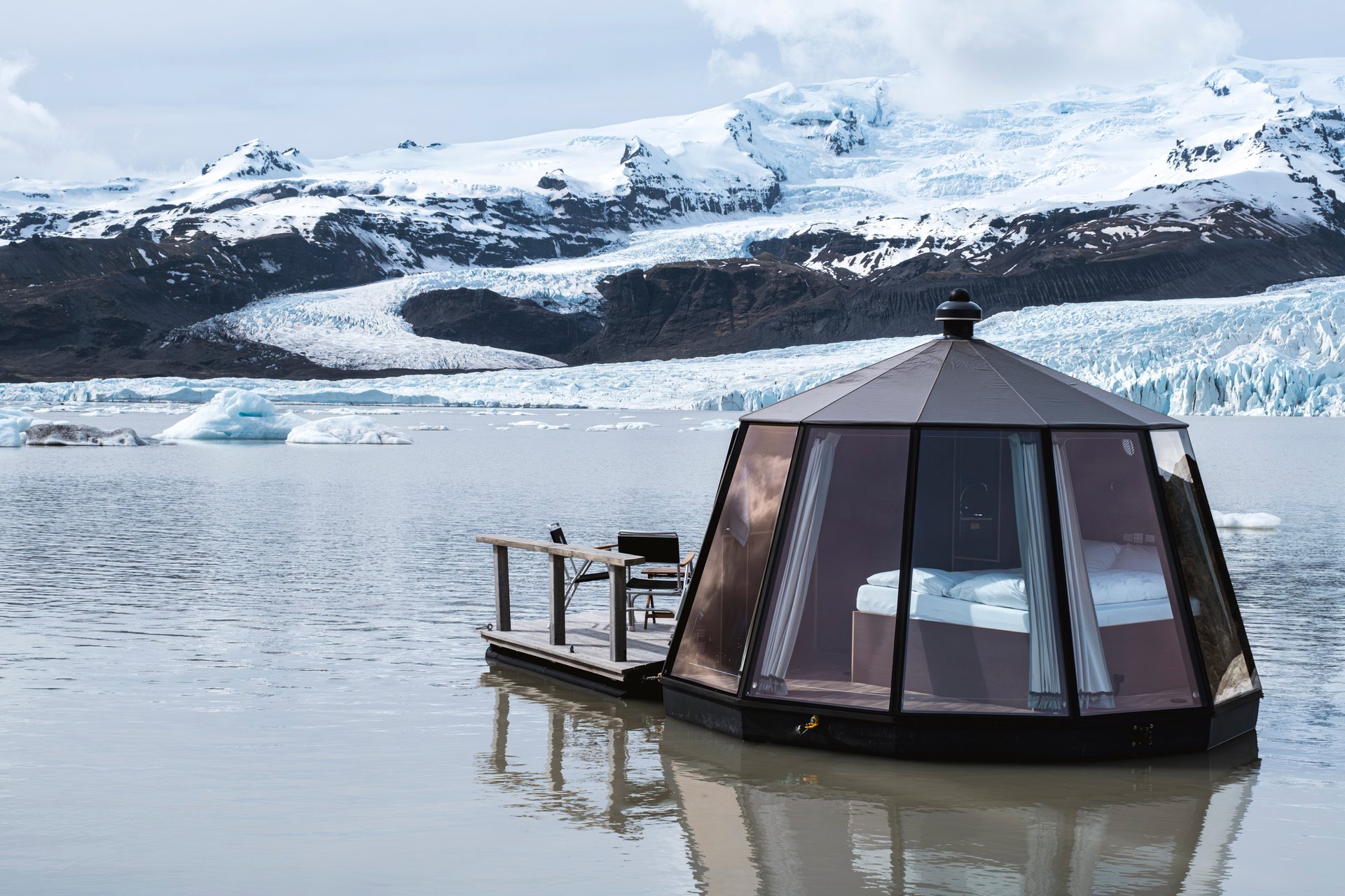 Floating glass hut at twilight on Fjallsárlón glacier lagoon Iceland