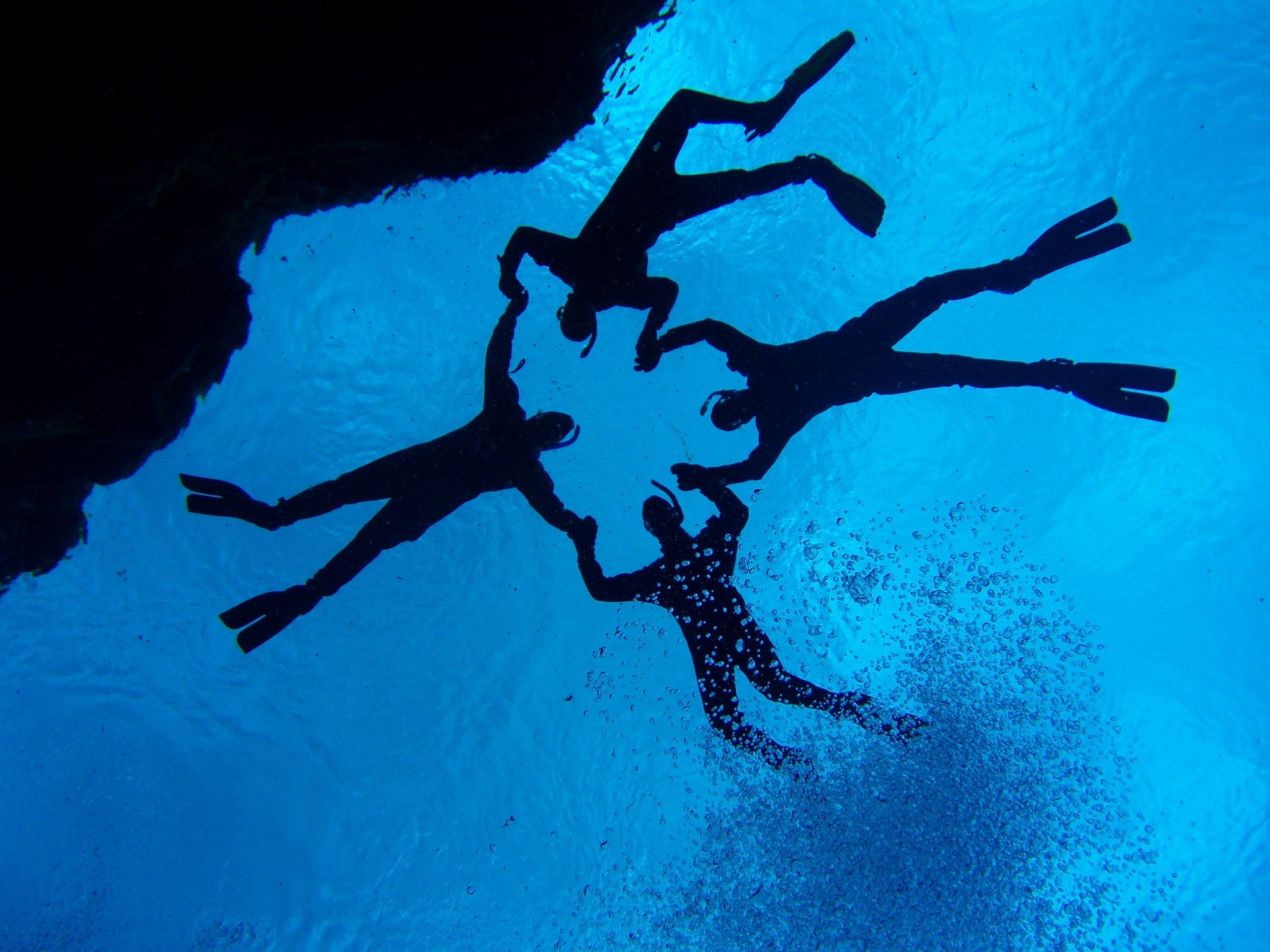 Snorkeler swimming between North American and Eurasian tectonic plates at Silfra fissure