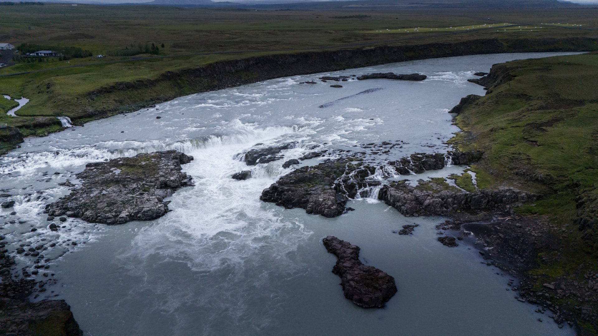 Gluggafoss hidden waterfall with natural window rock formations