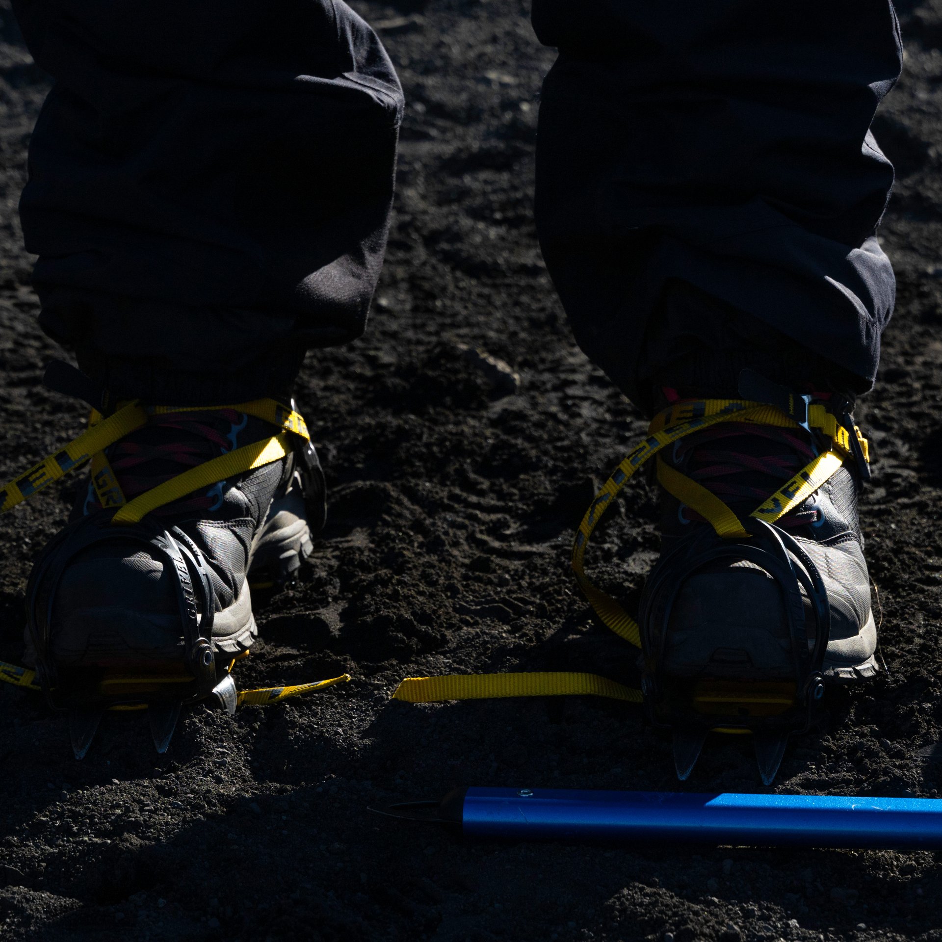 Adventure hikers equipped with crampons exploring glacier surface