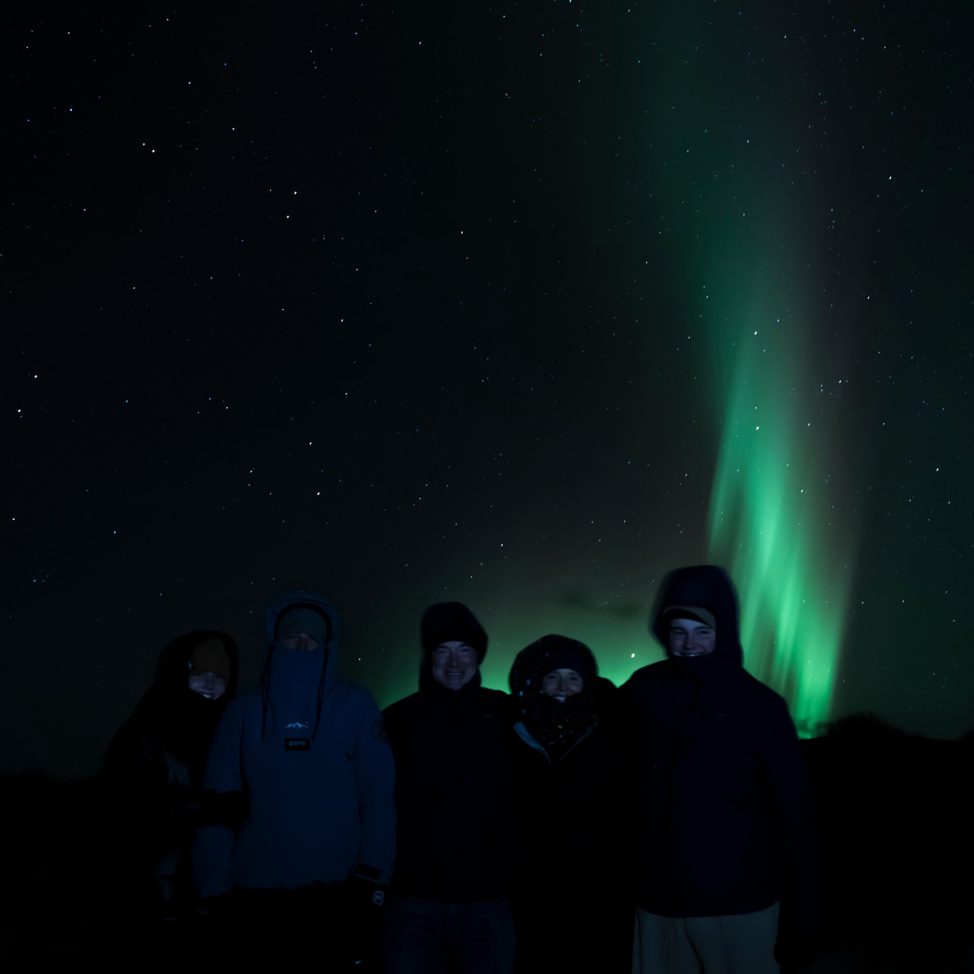 Aurora Borealis over dramatic Icelandic landscape with mountains
