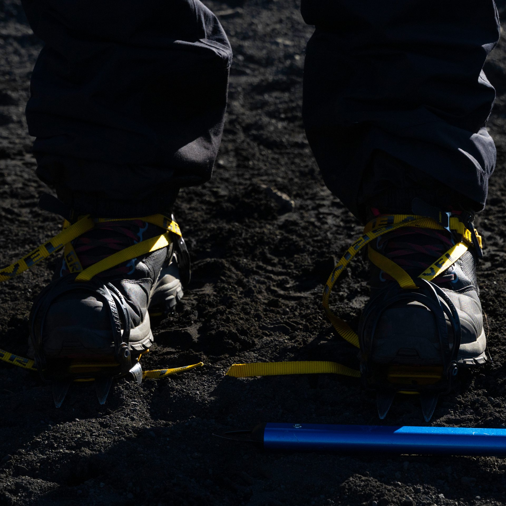 Guide and participants walking over a glacier crevasse