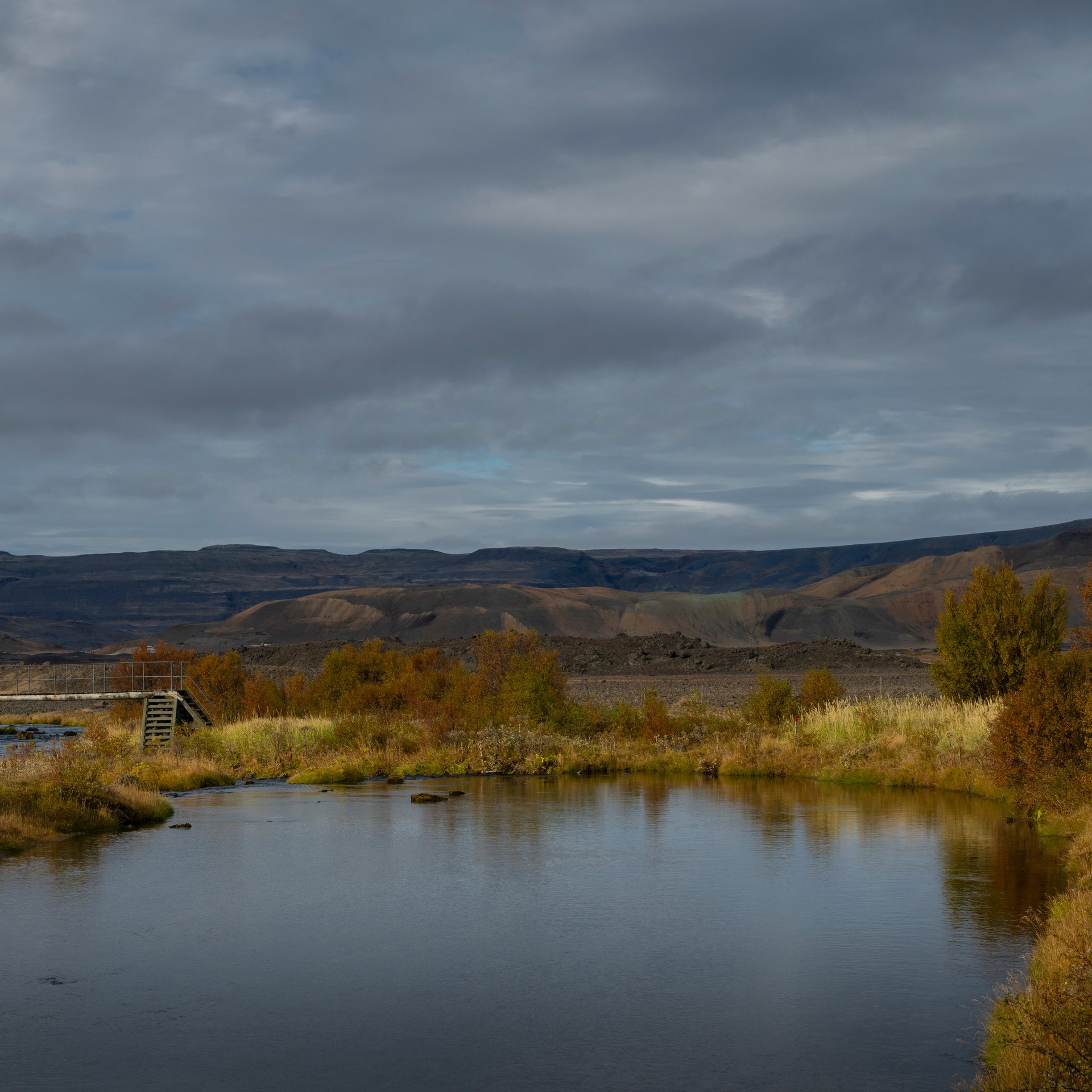 Lush Gjáin valley with multiple small waterfalls and green vegetation