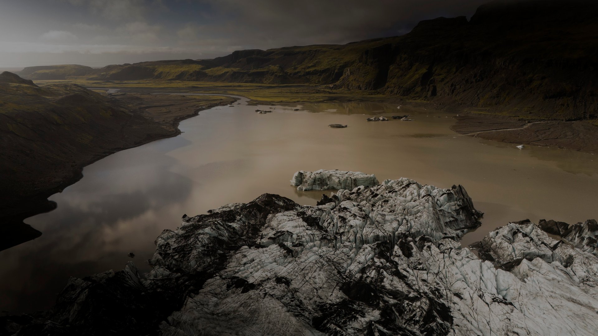 Adventurers equipped with crampons exploring the blue ice formations of Sólheimajökull glacier