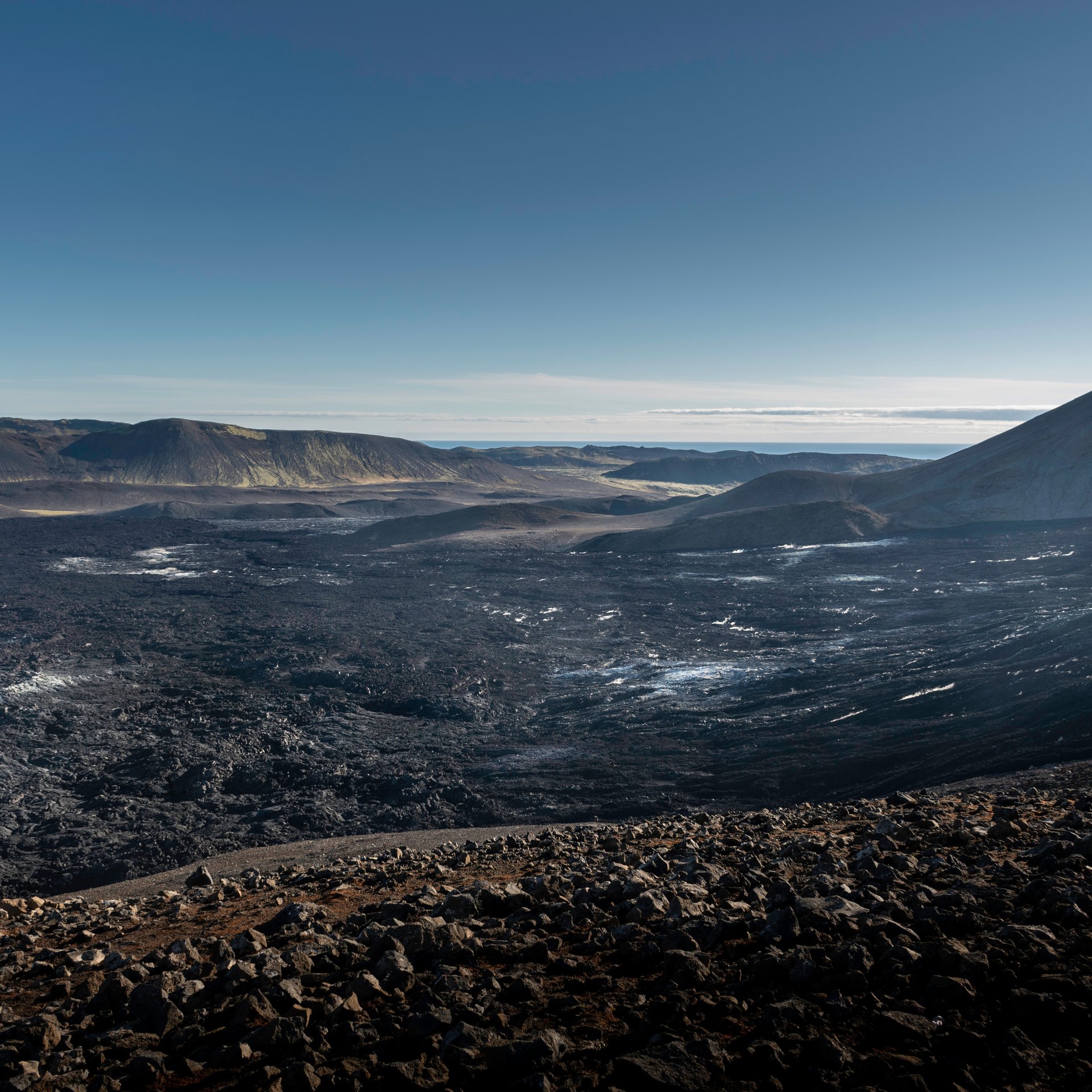 Hikers walking through fresh solidified lava fields on the Fagradalsfjall trail