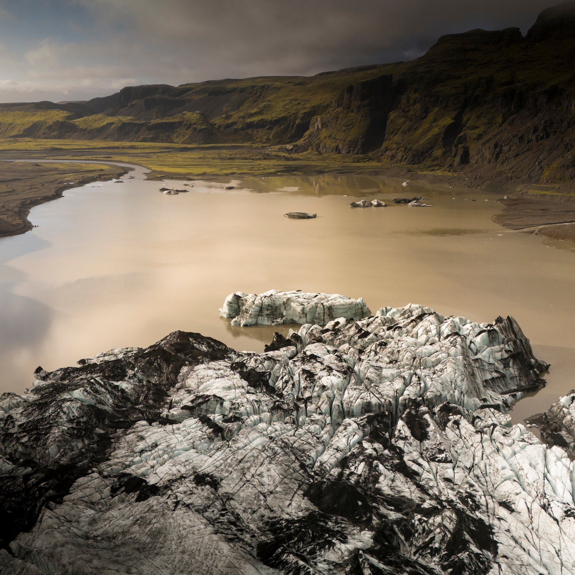 Glacier guide explaining ice formation science with dramatic glacier backdrop and safety equipment