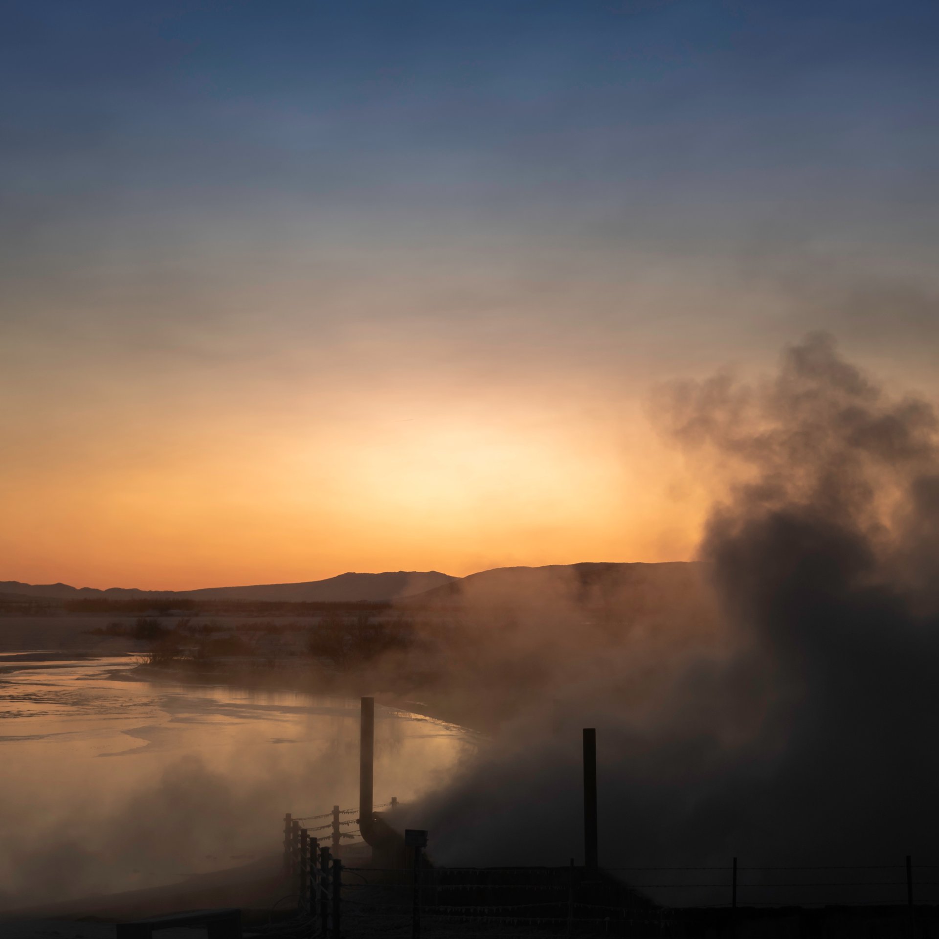 Relaxing geothermal hot spring at Laugarvatn with volcanic mountain backdrop