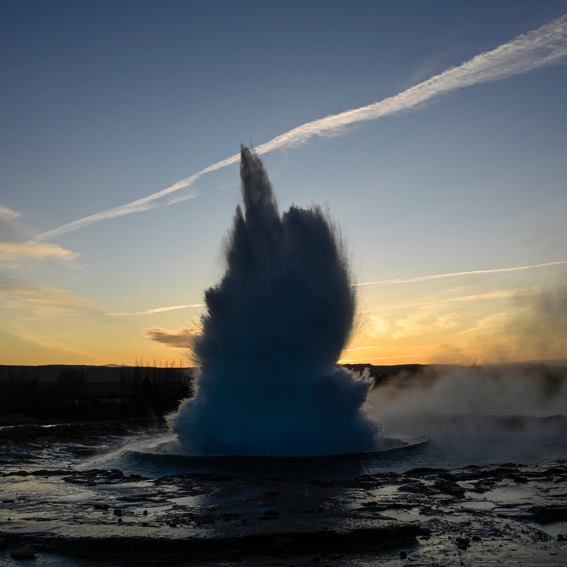 Strokkur geyser erupting with hot water and steam at Geysir geothermal area