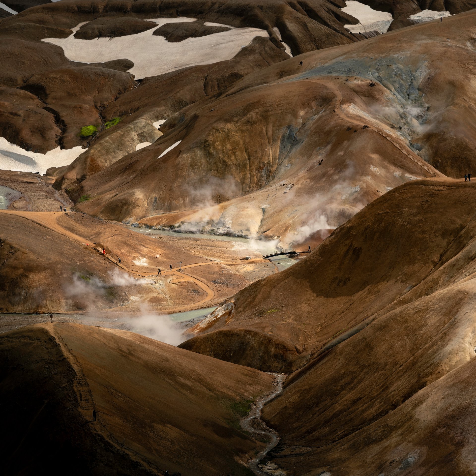Steaming Hveradalir geothermal valley with colorful mineral deposits and hot springs