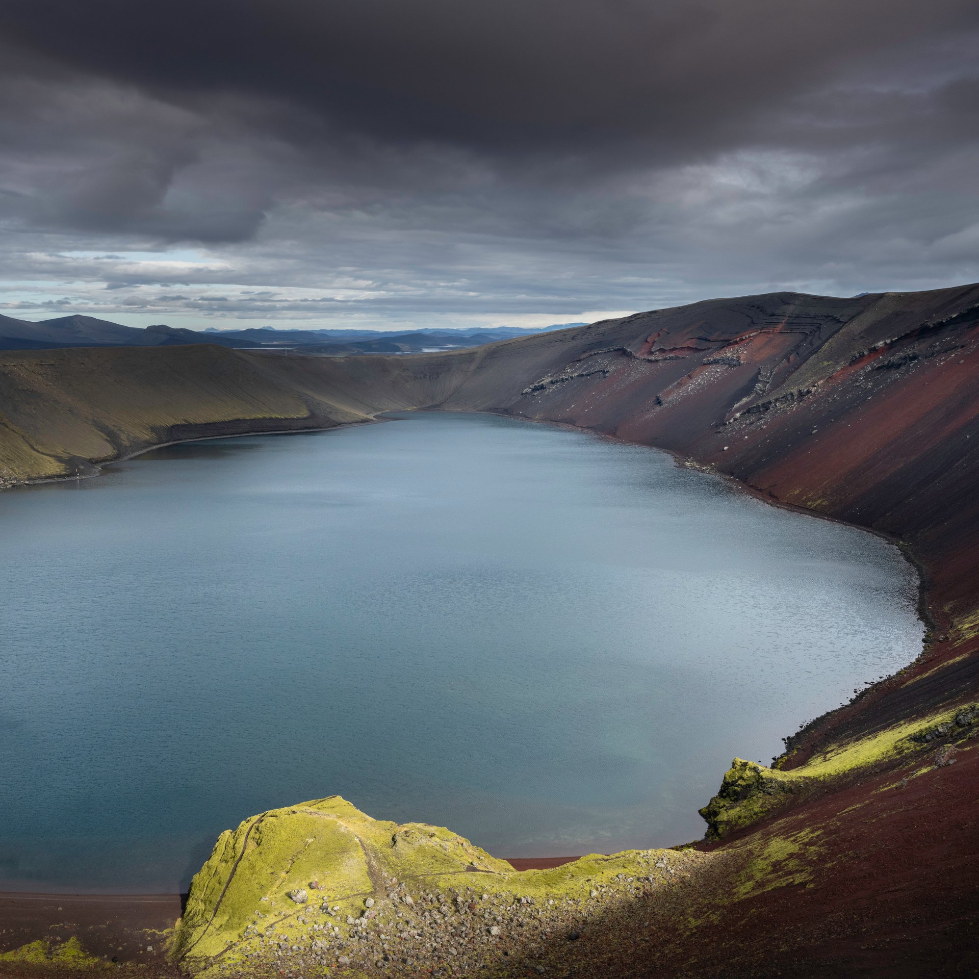 Spectacular circular Ljótipollur crater lake with crystal-clear water and volcanic rim
