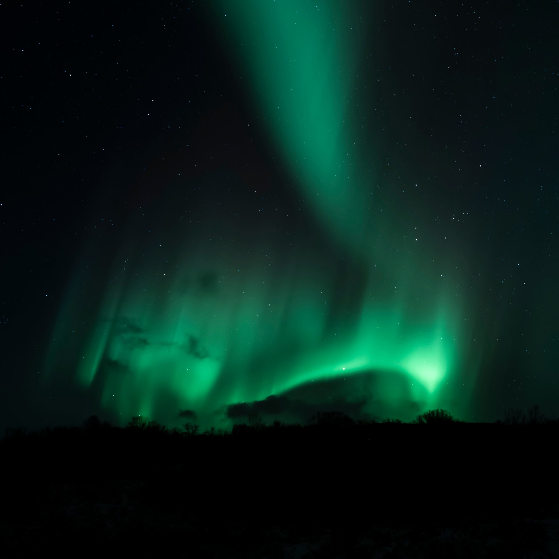 Aurora Borealis photography session with tripod and camera setup under Northern Lights