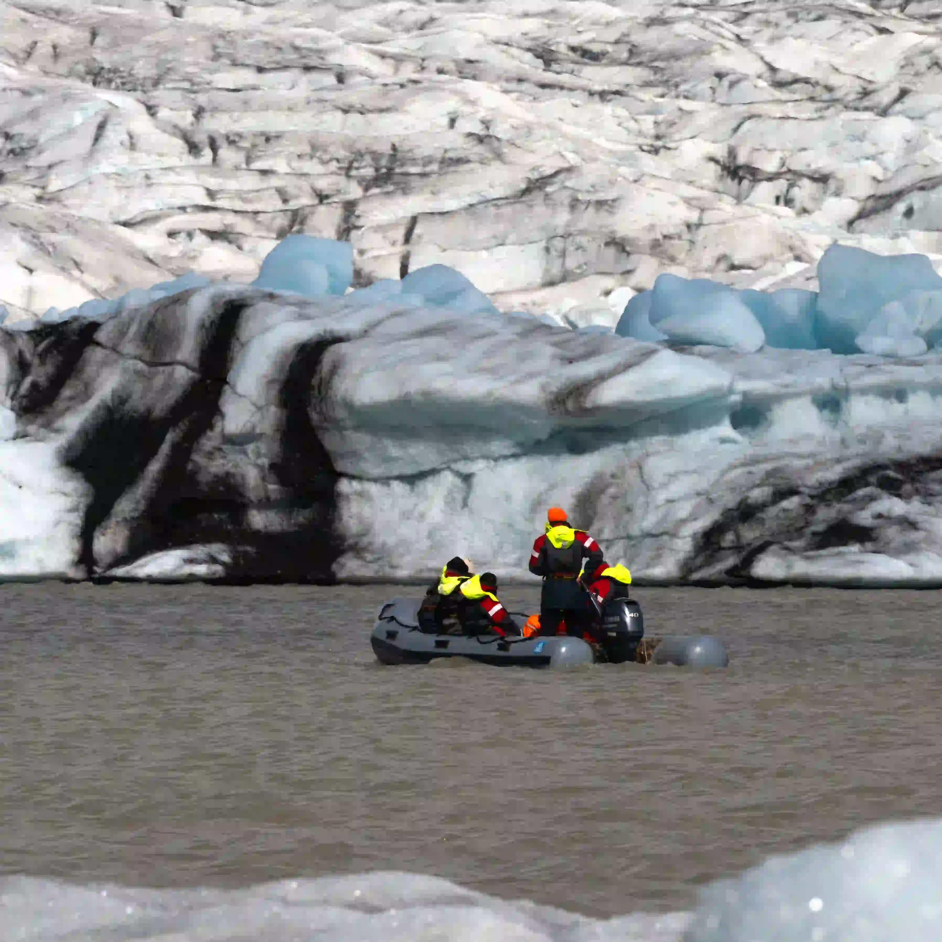 Zodiac boat tour navigating among icebergs at Fjallsárlón glacier lagoon