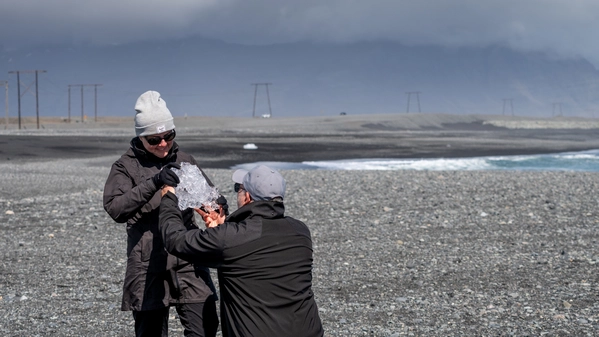 Read our blog article People enjoying their tour in Iceland on a black sand beach