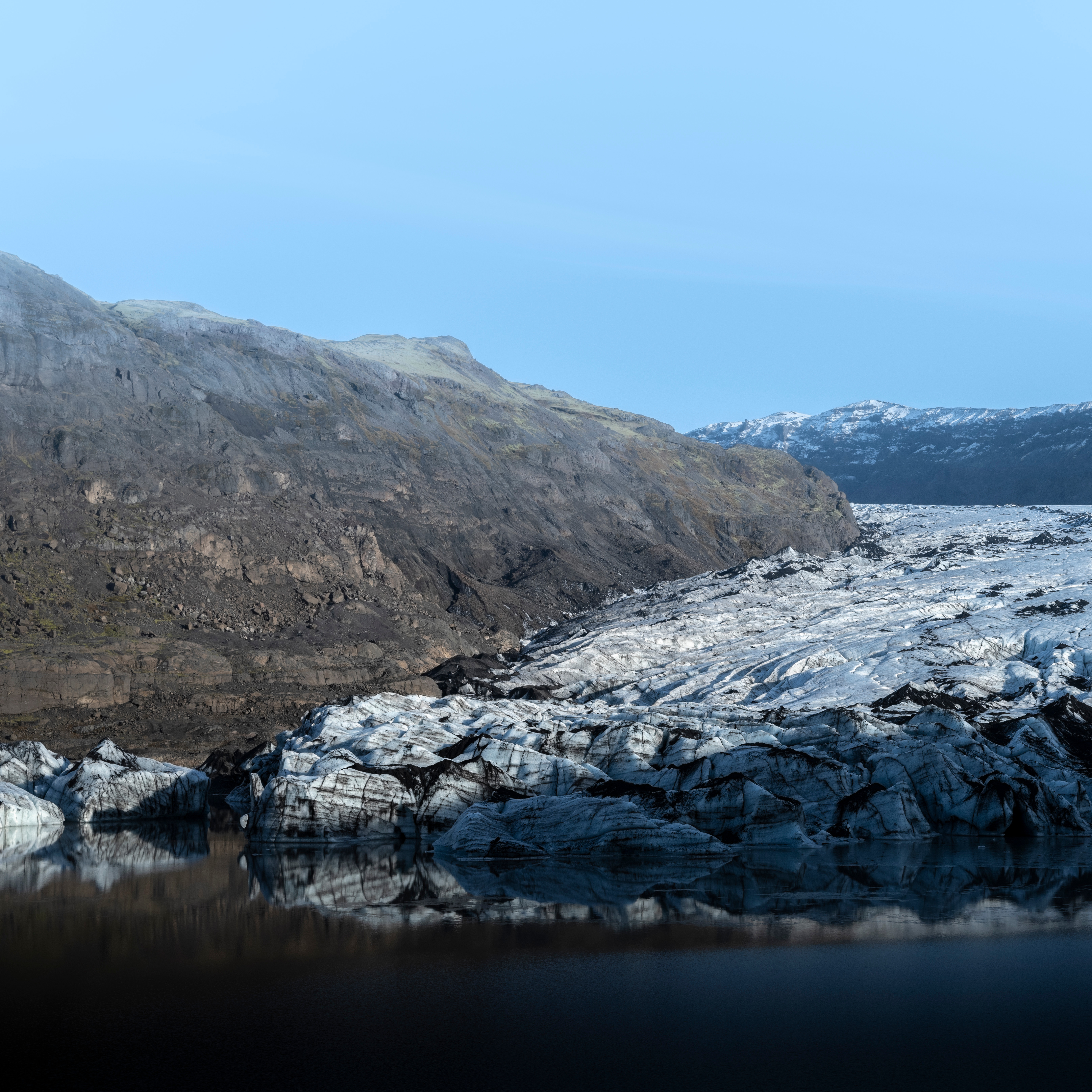 Travelers crossing ancient ice during a Sólheimajökull glacier hiking adventure